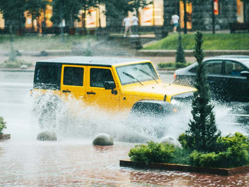 Yellow Jeep driving through flooded Twin Cities, MN streets