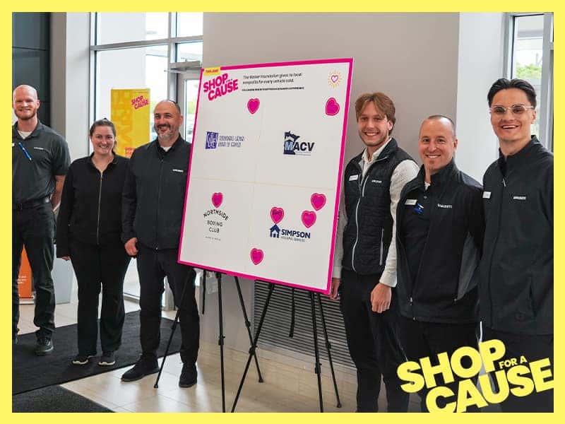 Shop For A Cause 2026 - Sales Team Posing by Donation Board