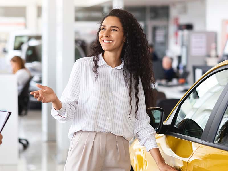 Woman test driving a yellow car