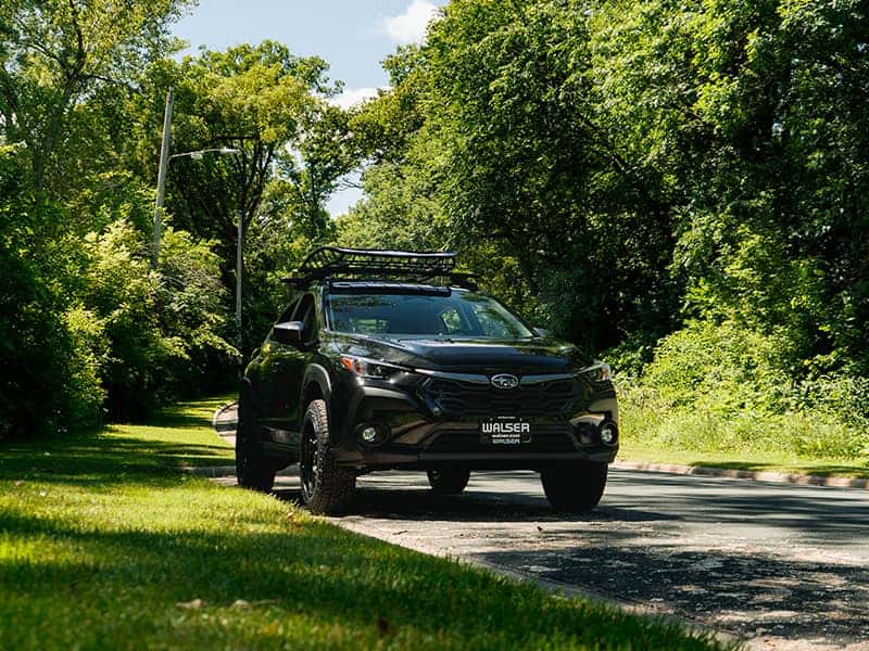 2026 Subaru Crosstrek parked at a Minnesota lakeside trailhead in summer