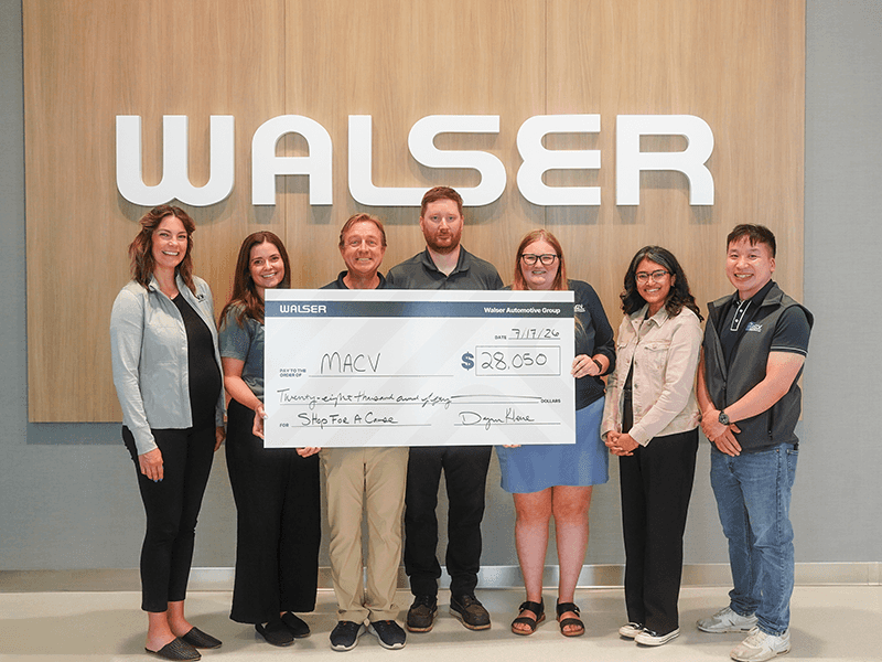 Walser employees deliver the large check to MACV