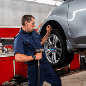 A man attaching a tire to a vehicle