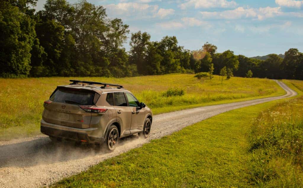 2025 Nissan Rogue Rock Creek driving on a country road