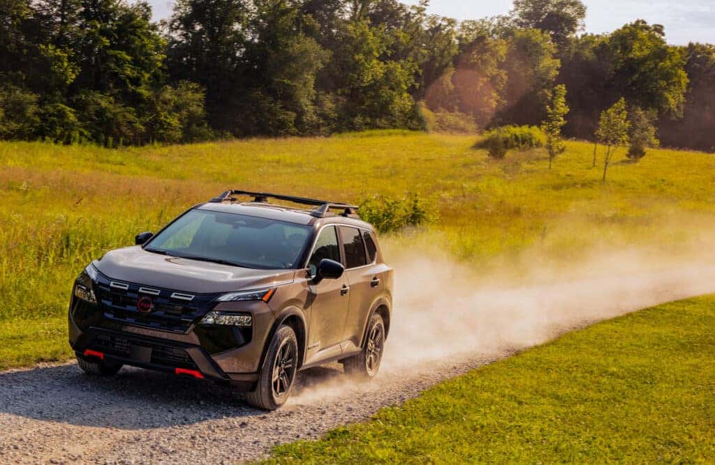 2025 Nissan Rogue Rock Creek driving on a country road