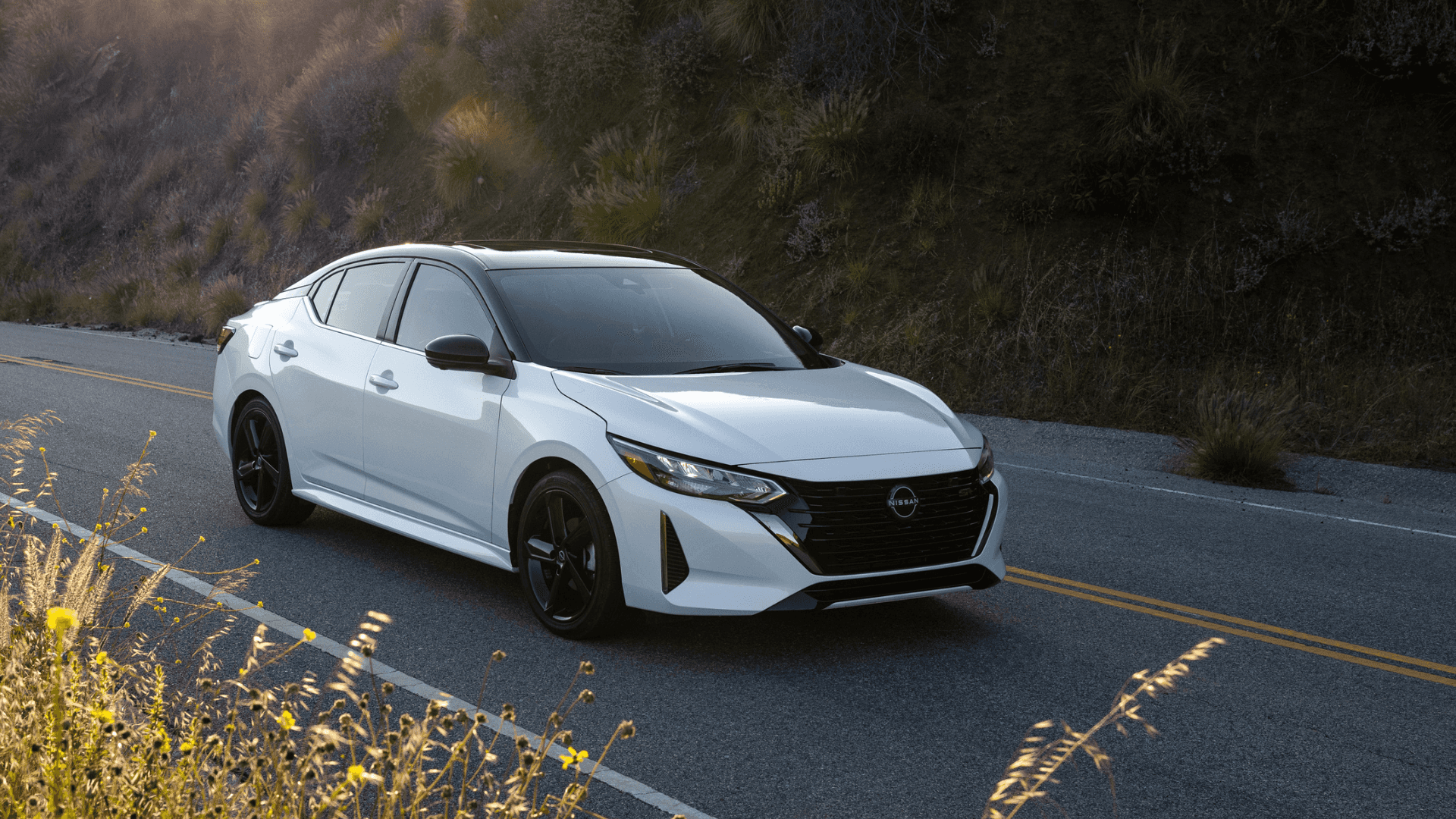 2025 Nissan Sentra driving on a paved road.