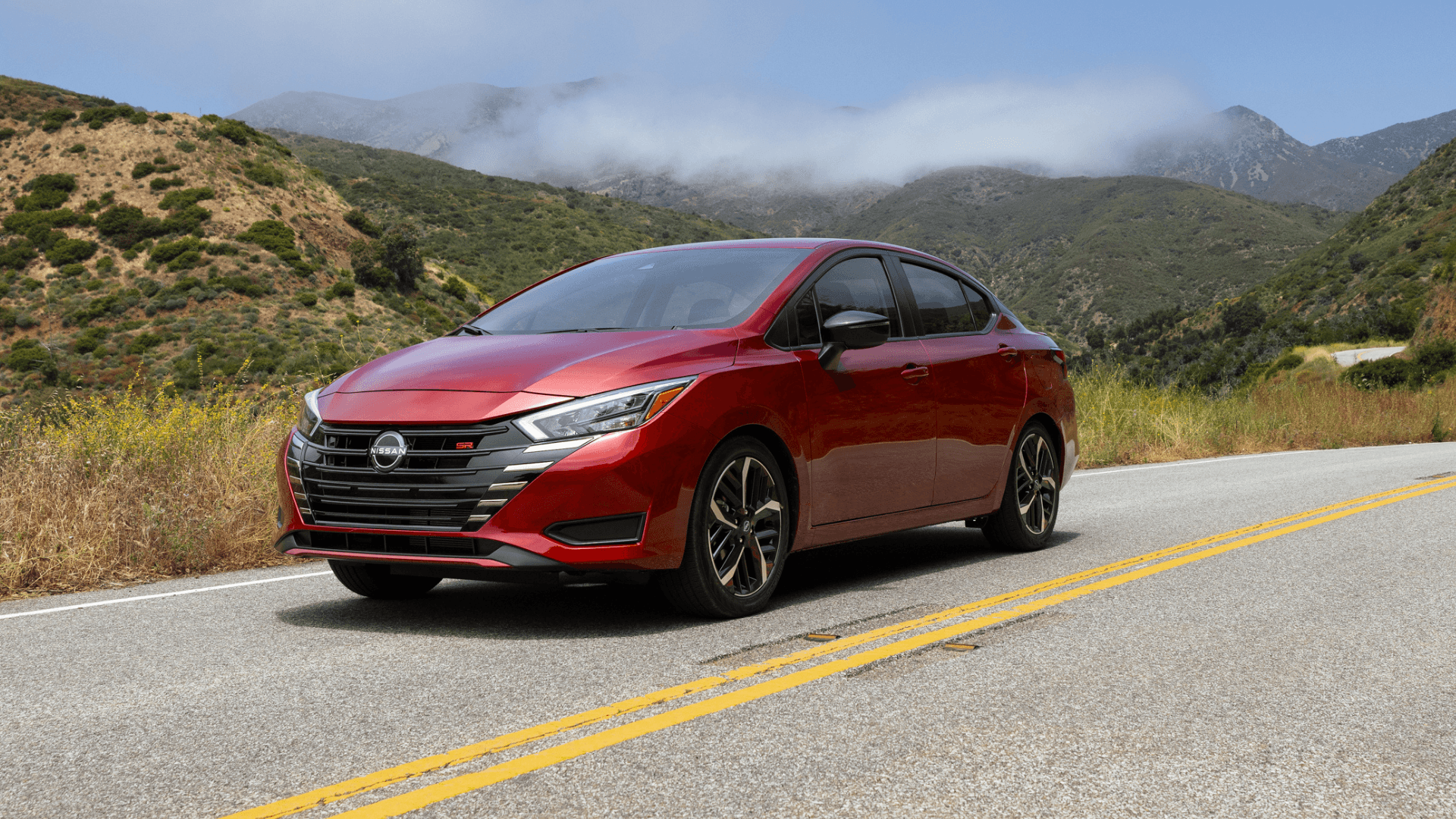 2025 Nissan Versa cruising down a highway.
