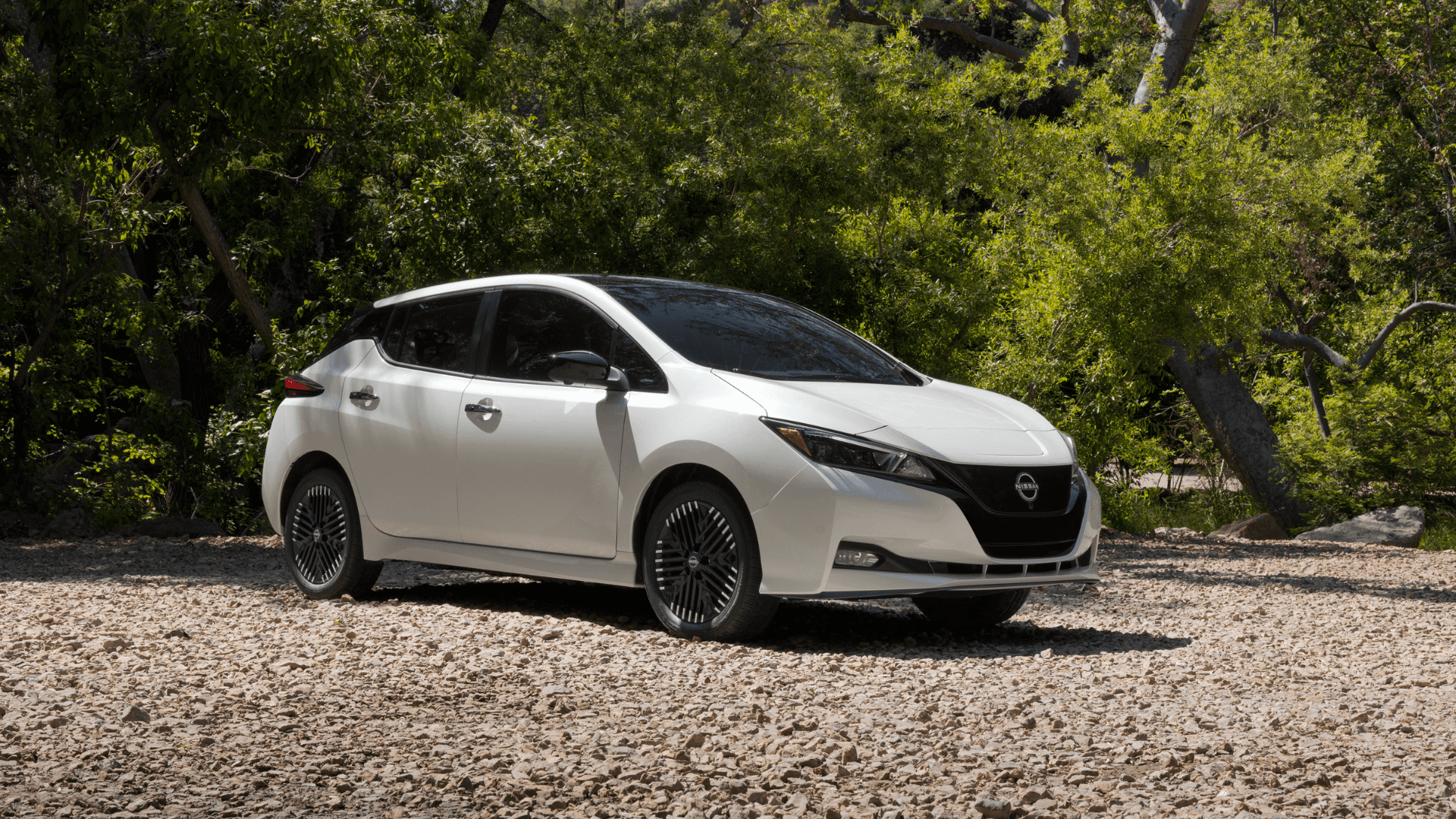 2025 Nissan Leaf driving through a city.