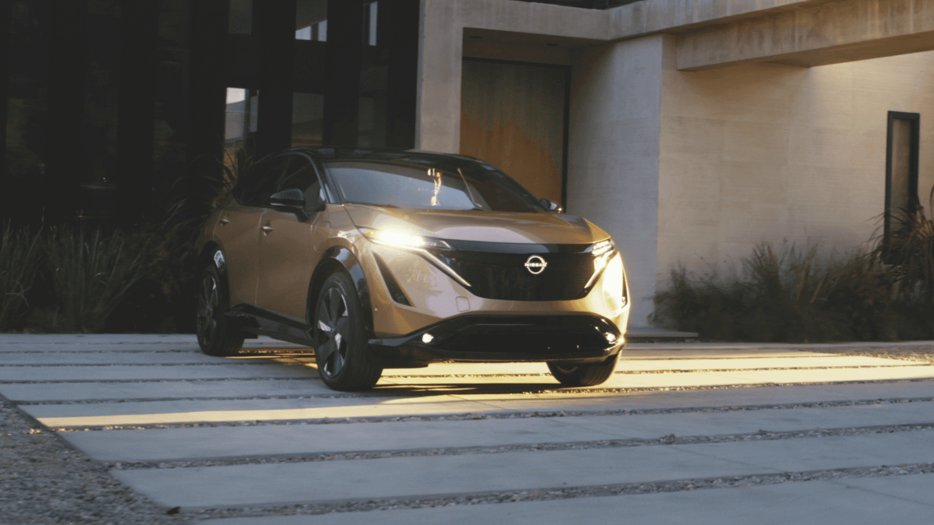 2025 Nissan Ariya parked at a charging station.