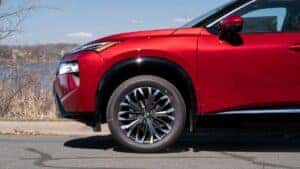 Front end and tires on a red 2024 Nissan Rogue