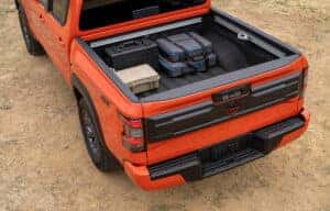 Truck bed with cargo on an orange 2025 Nissan Frontier