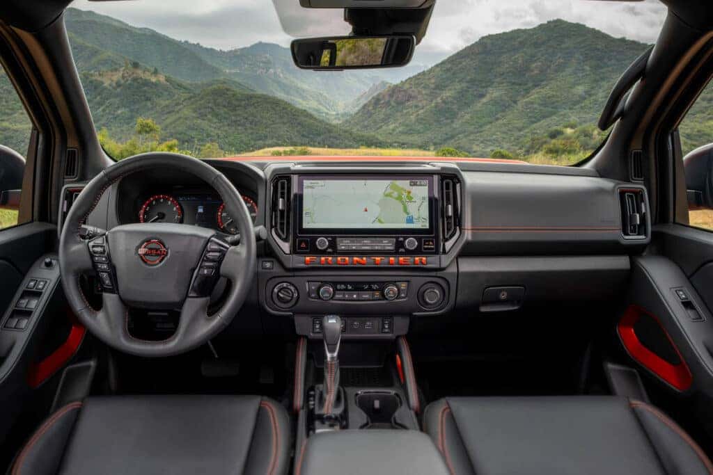 View from backseat of the driver's seat and infotainment screen on a 2025 Nissan Froniter