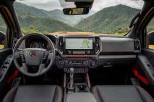 View from backseat of the driver's seat and infotainment screen on a 2025 Nissan Froniter