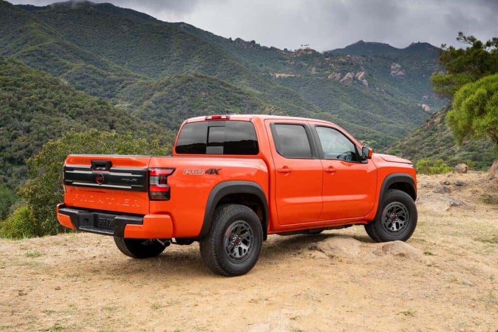 Orange 2025 Nissan Frontier parked in front of mountains