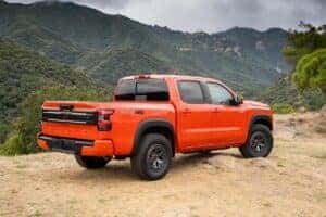 Orange 2025 Nissan Frontier parked in front of mountains