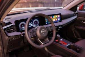 view of 2025 nissan kicks interior steering wheel and display screen