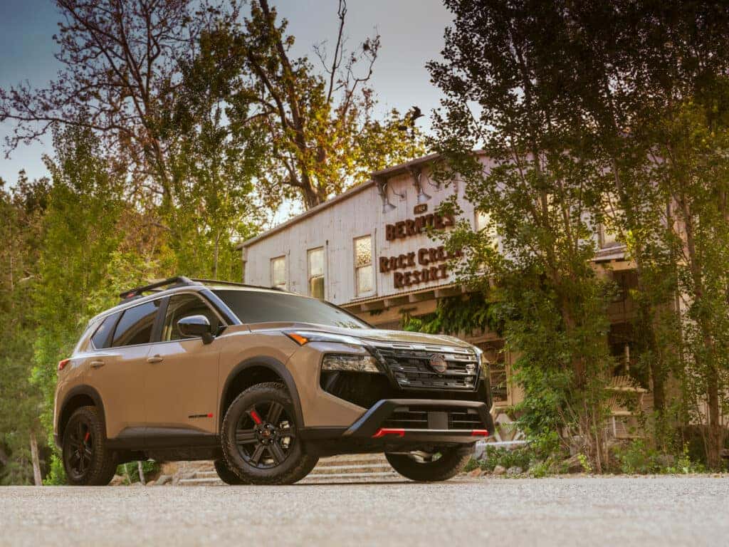 2025 Nissan Rogue Rock Creek parked in front of a building