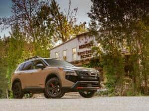2025 Nissan Rogue Rock Creek parked in front of a building