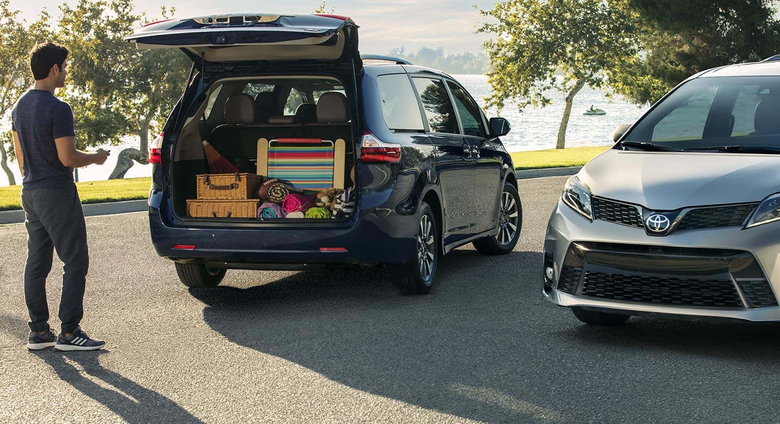 2 Toyota Sienna Minivans with trunk open storing items
