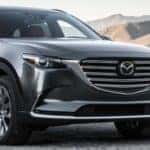 Image of a gray 2019 Mazda CX-9 parked in front of a mountain backdrop.