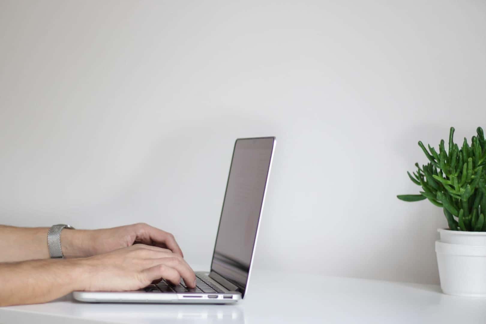 hands resting on a laptop